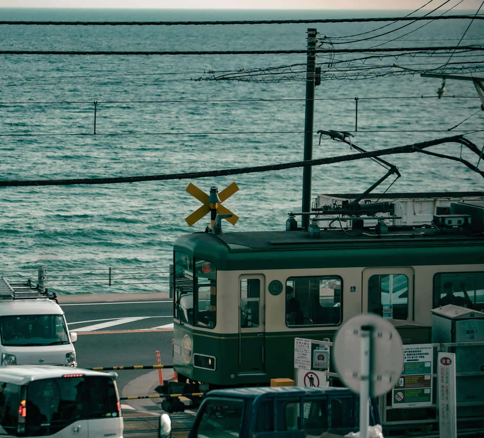 Enoden train passing Kamakura High School crossing along the Shonan coast